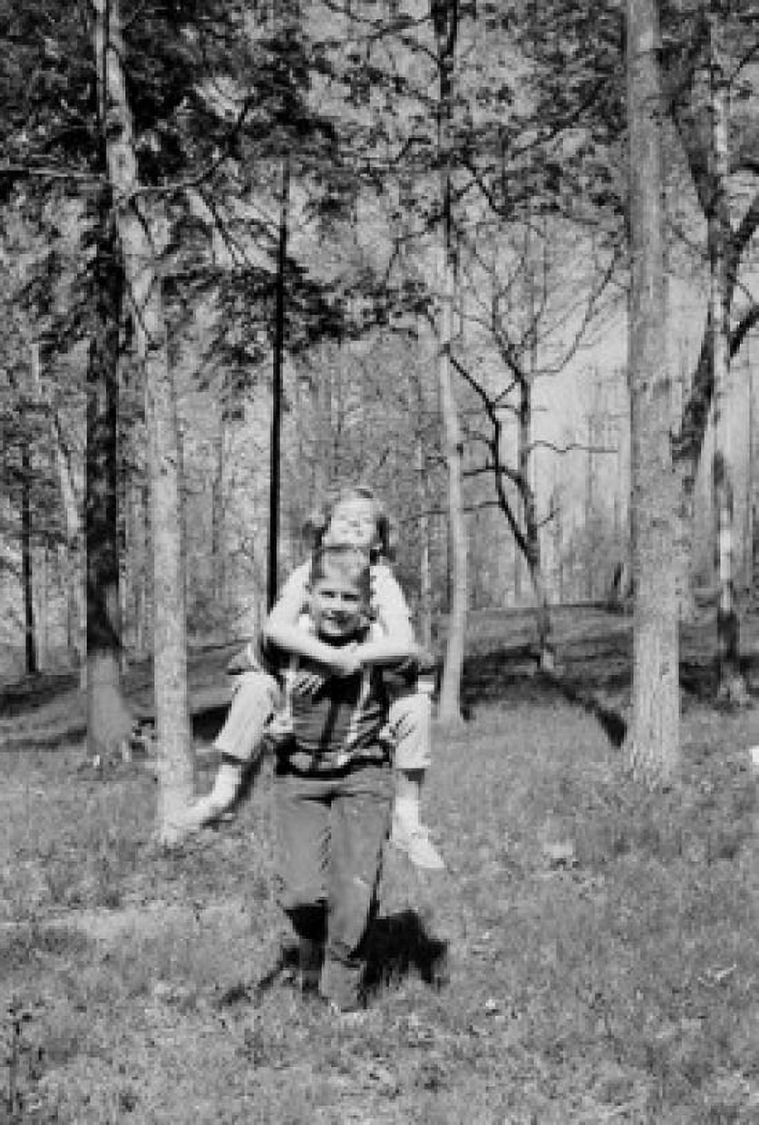 Girl piggyback riding on boy in forest Canvas Art - (18 x 24)