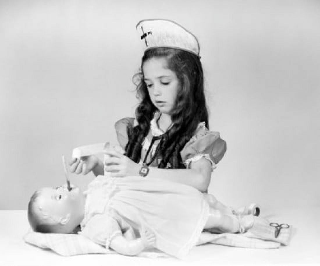 Girl playing nurse taking care of doll Canvas Art - (18 x 24)