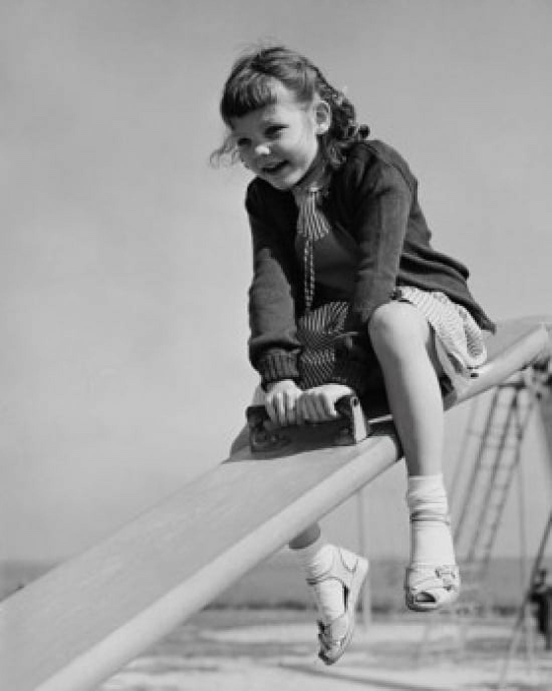 Girl playing on a seesaw Canvas Art - (18 x 24)