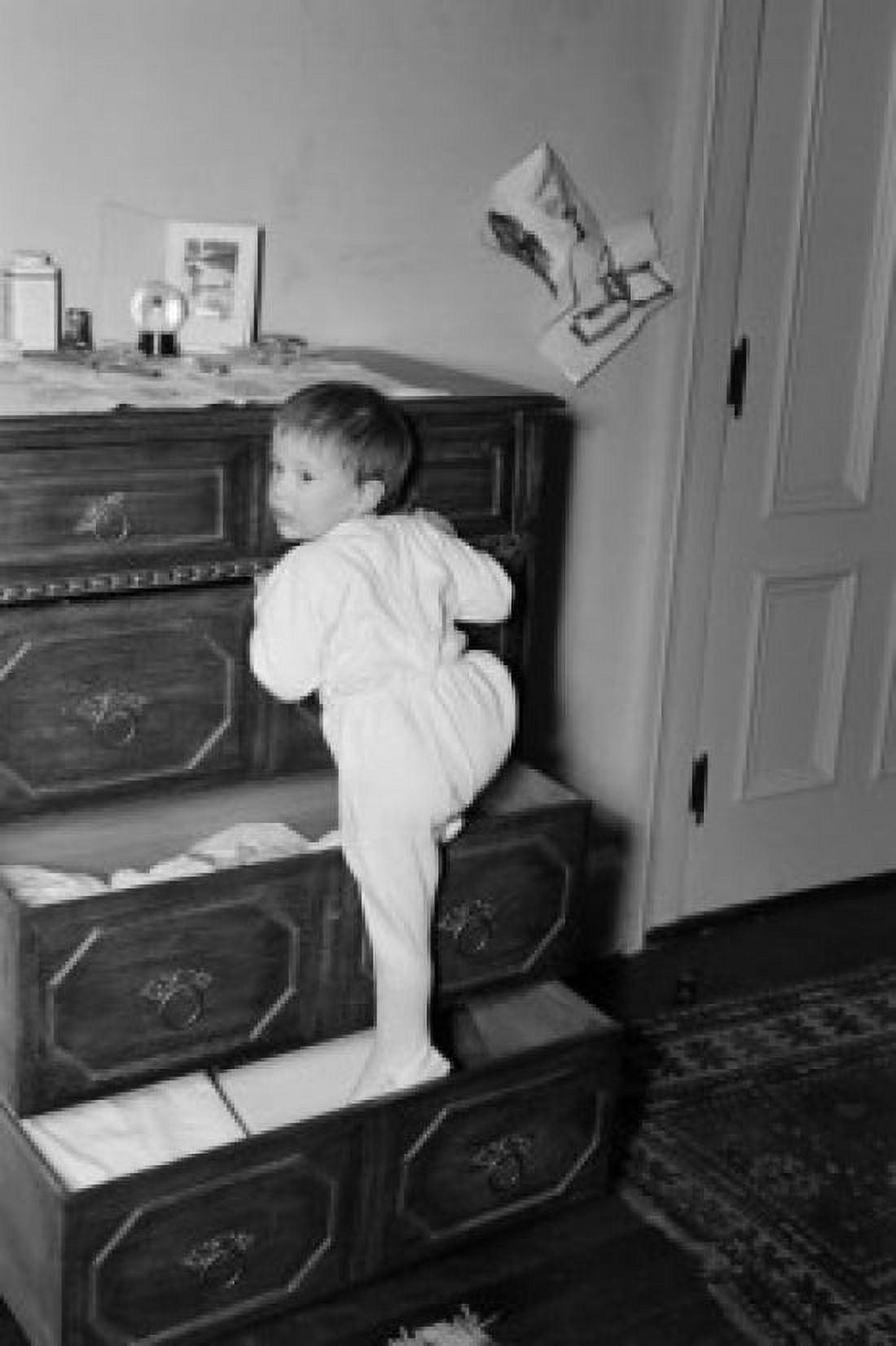 Girl playing on drawer chest Canvas Art - (24 x 36)