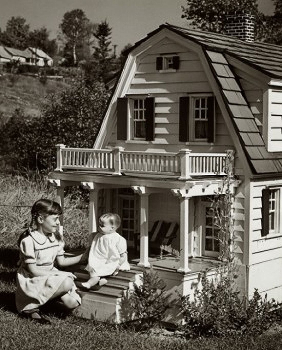 Girl playing with a doll in front of a dollhouse Canvas Art - (18 x 24)