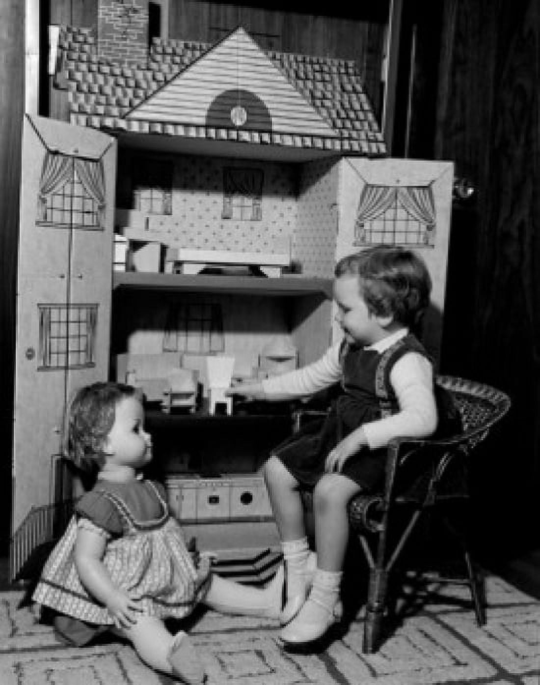 Girl playing with dollhouse Canvas Art - (18 x 24)