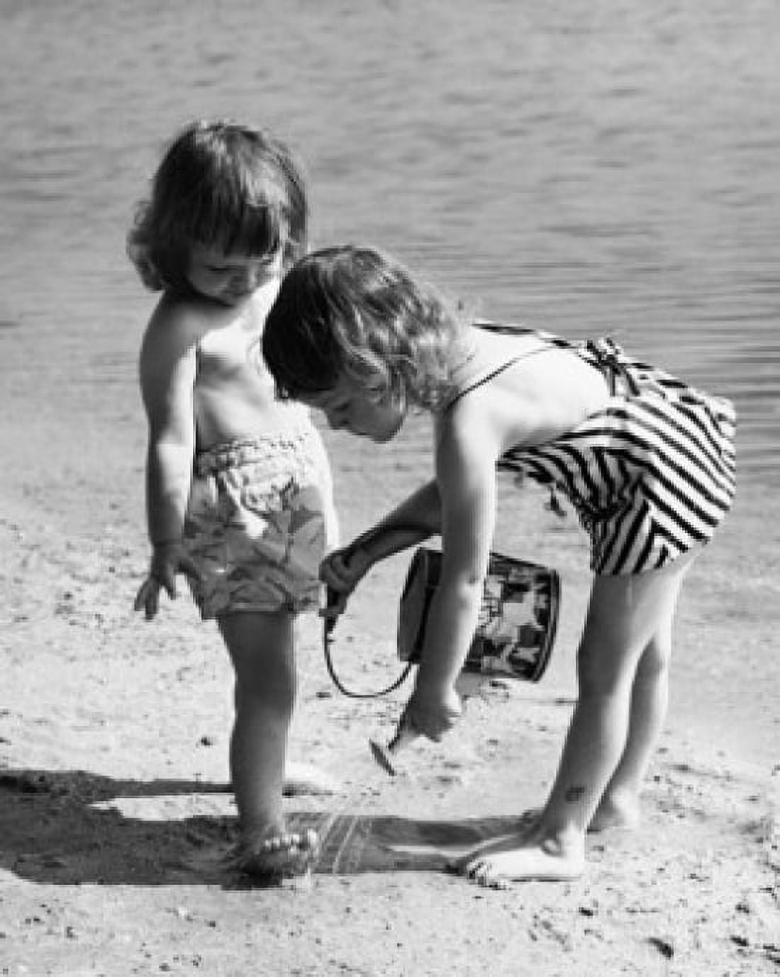 Girl pouring water on the foot of another girl on the beach Canvas Art - (18 x 24)