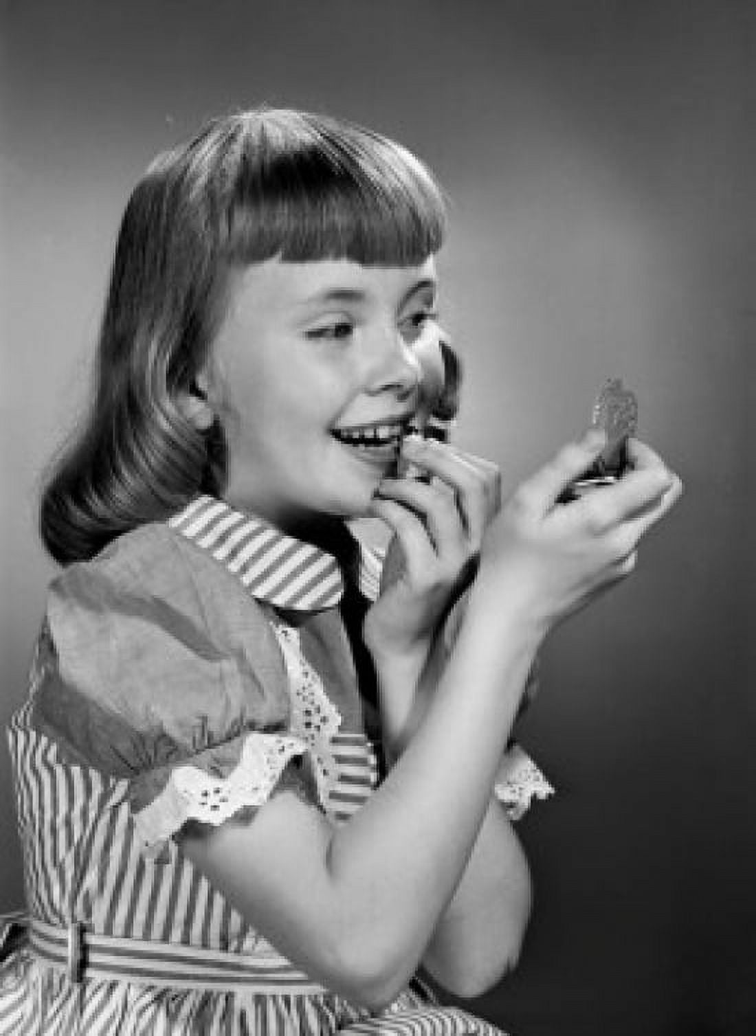 Girl putting lipstick on Canvas Art - (24 x 36)
