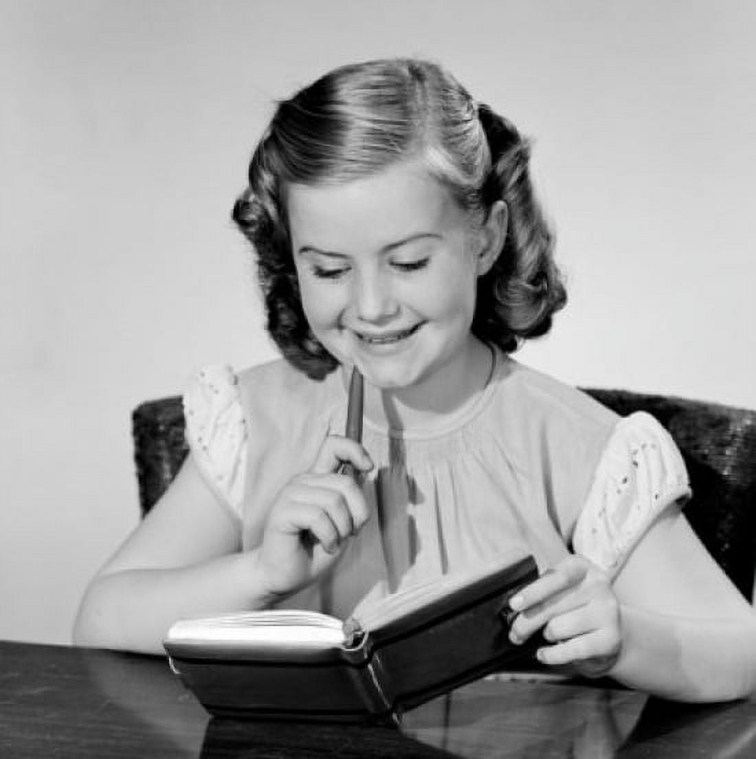 Girl reading diary at table Canvas Art - (18 x 24)