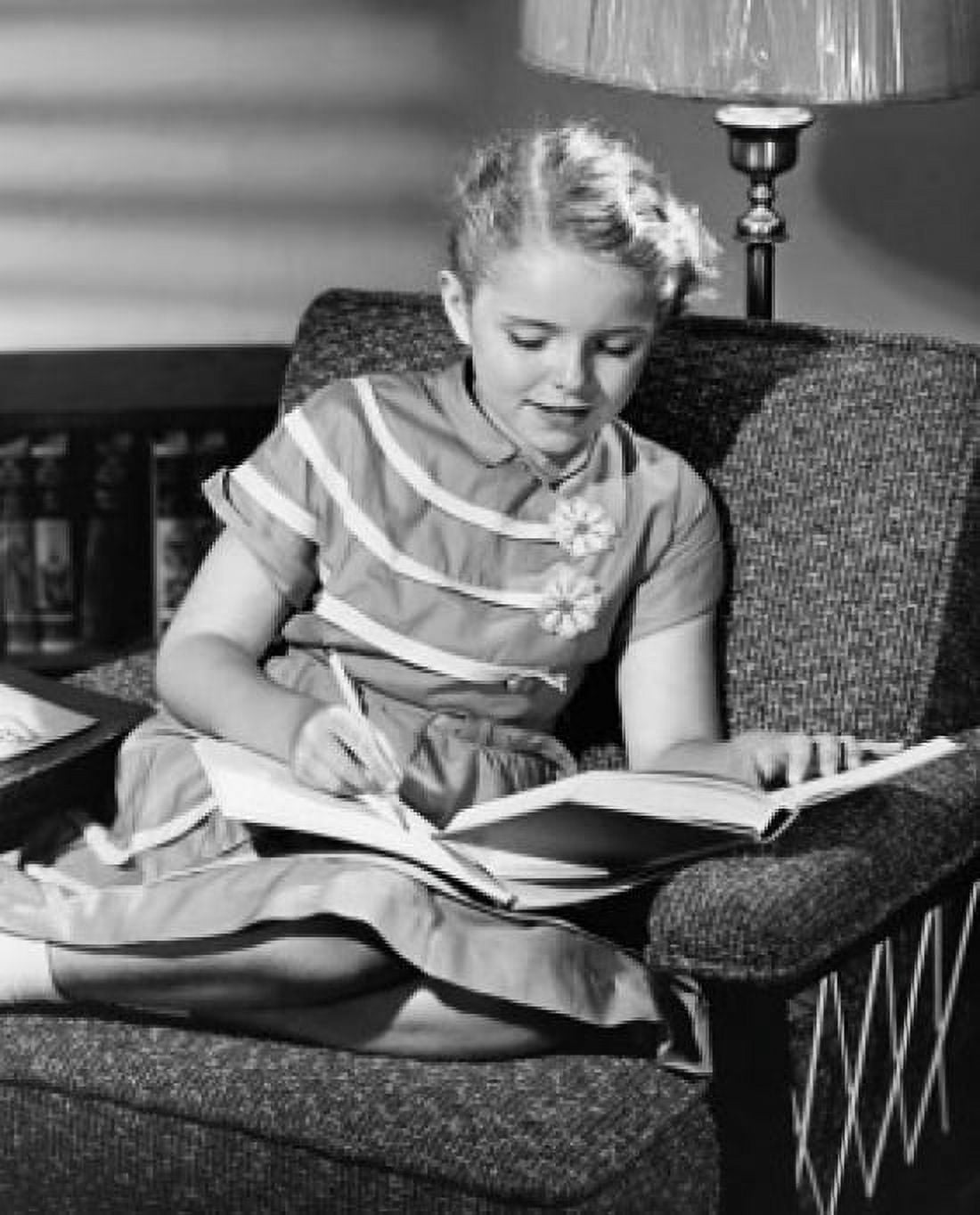 Girl sitting in an armchair and studying Canvas Art - (24 x 36)