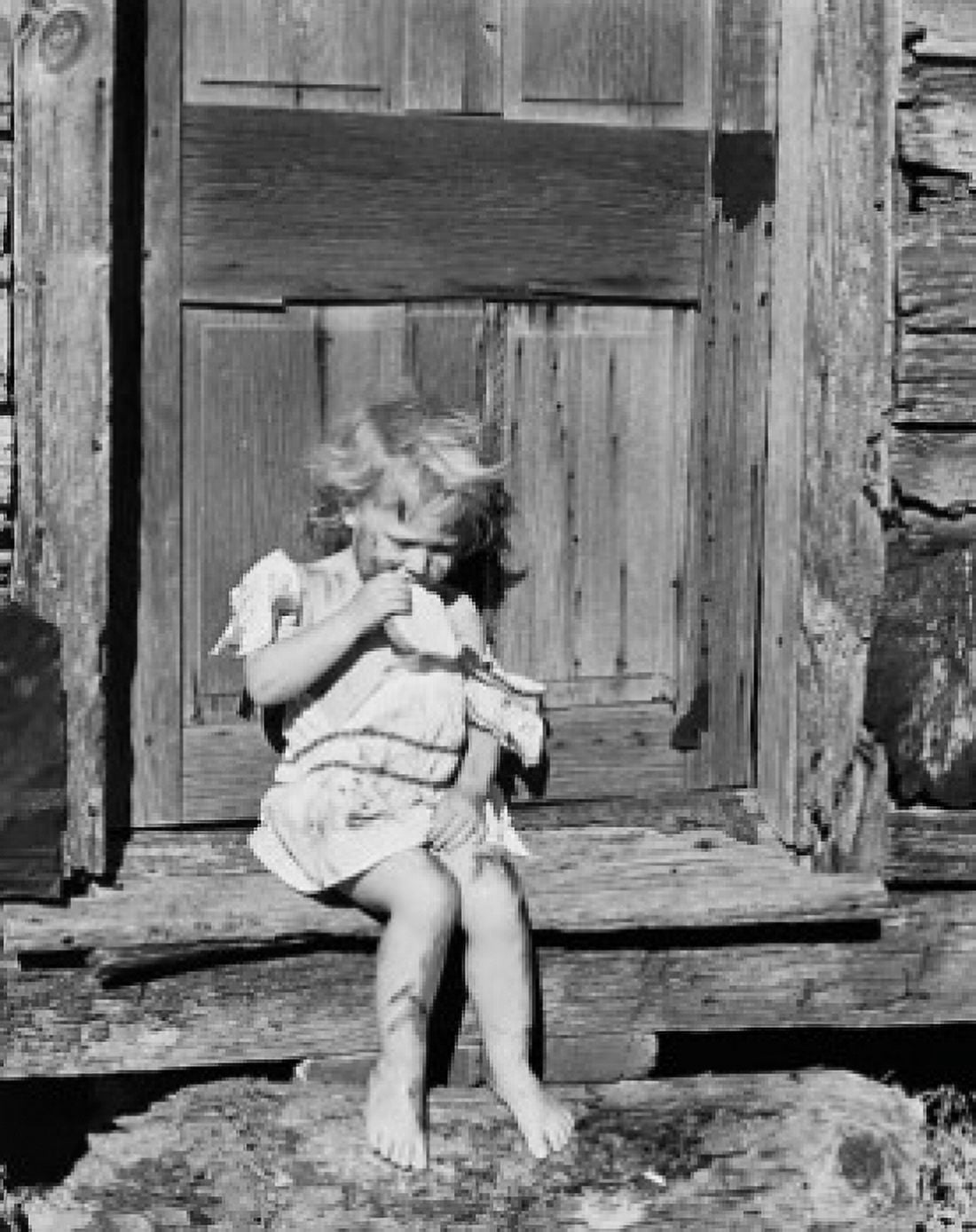 Girl sitting on a doorstep and eating bread Canvas Art - (18 x 24)