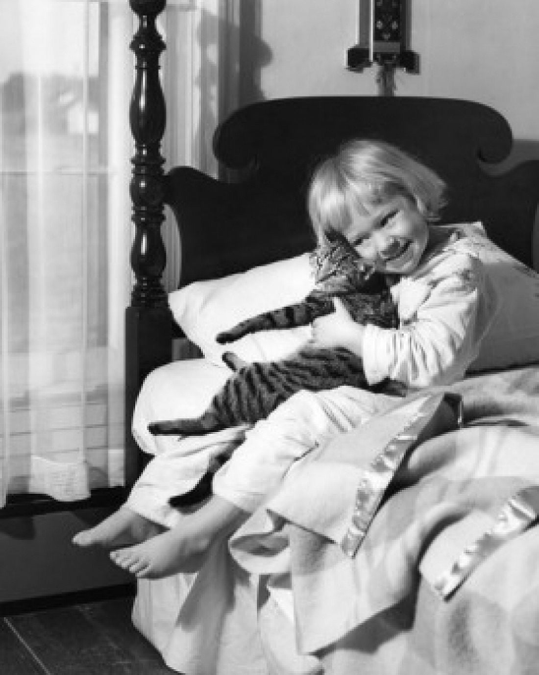 Girl sitting on bed and holding cat Canvas Art -  (18 x 24)