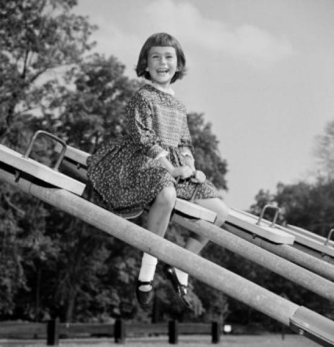 Girl sitting on seesaw laughing Canvas Art - (18 x 24)