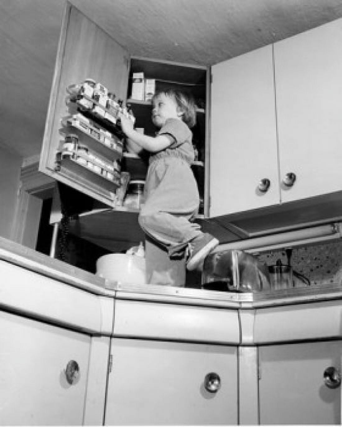 Girl standing on kitchen worktop looking in cupboard Canvas Art - (18 x 24)