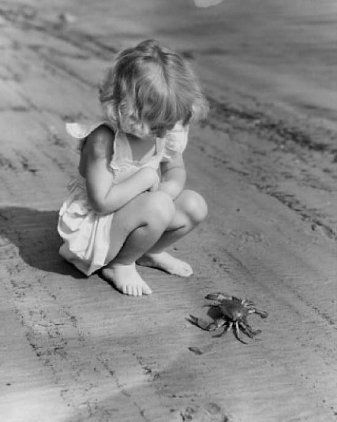 Girl watching a crab on the beach Canvas Art - (24 x 36)