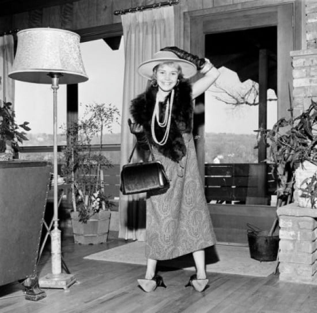 Girl wearing mothers clothing standing in living room Canvas Art - (24 x 36)