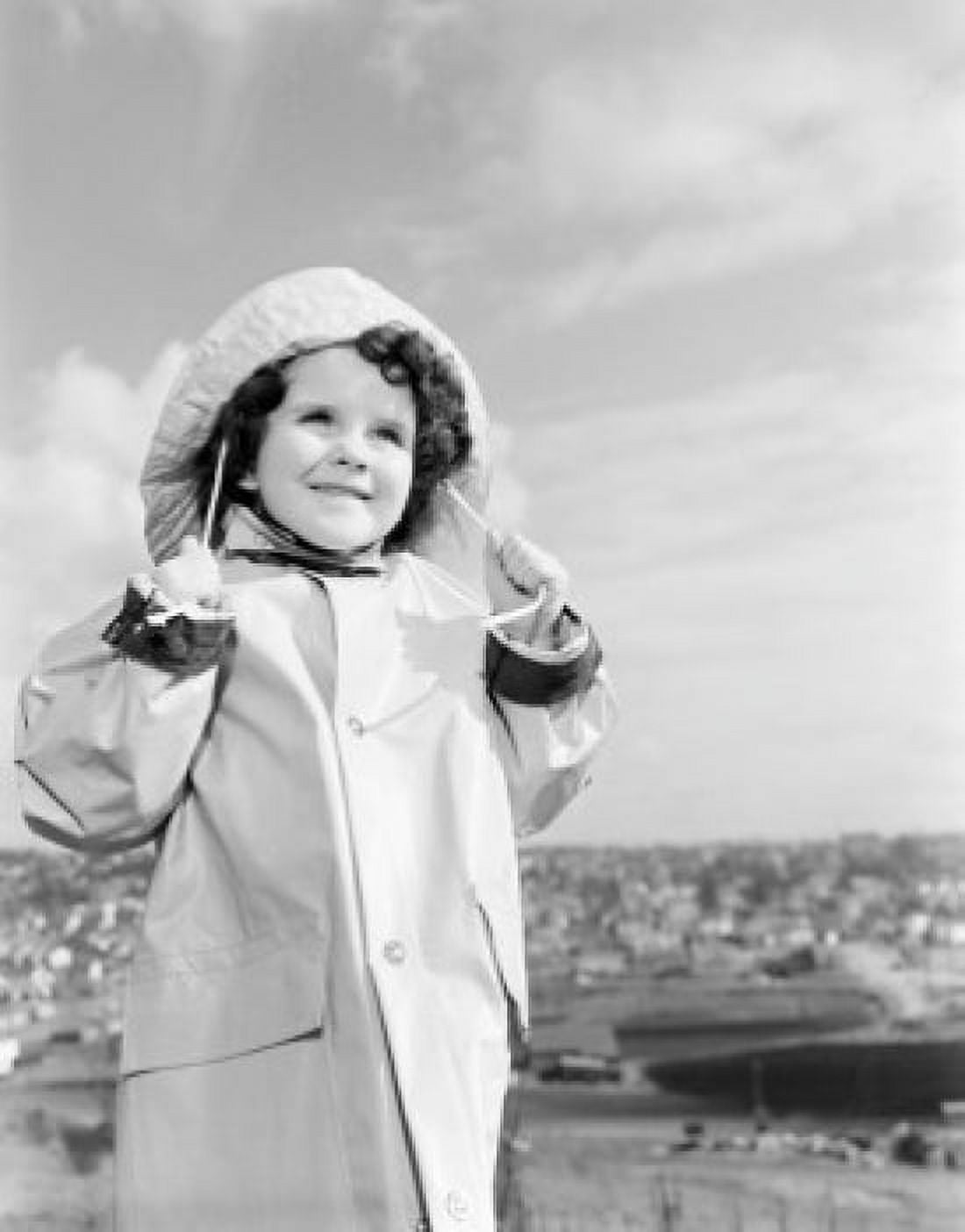Girl wearing raincoat looking away and smiling Canvas Art - (18 x 24)