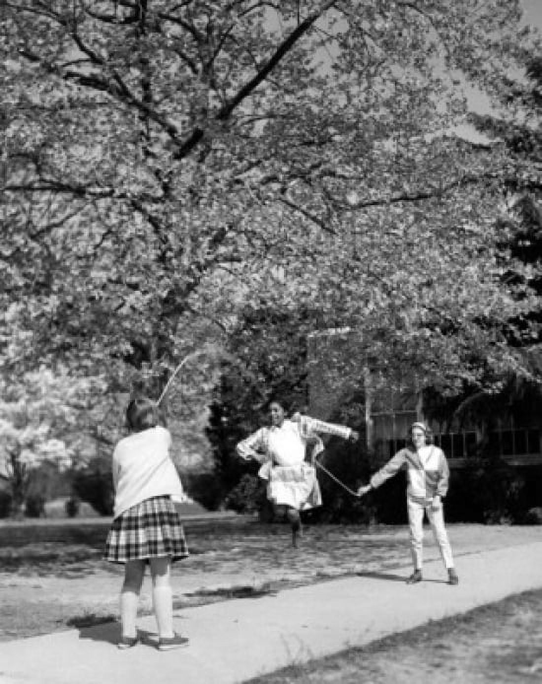 Girls playing with jump rope in the park Canvas Art - (18 x 24)