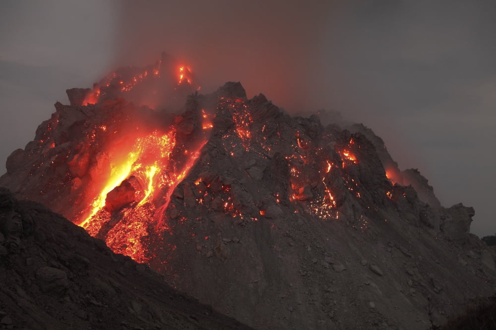 Glowing Rerombola lava dome of Paluweh volcano Indonesia Canvas Art - Richard RoscoeStocktrek Images (35 x 23)