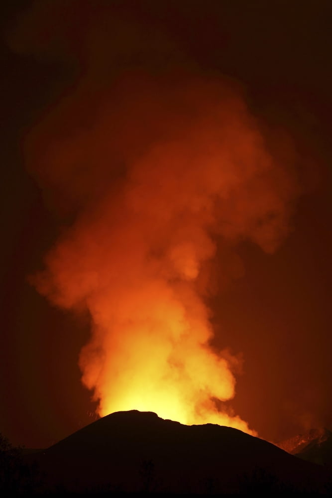 Glowing lava in crater illuminating gas cloud above Nyamuragira Volcano Canvas Art - Richard RoscoeStocktrek Images (12 x 18)