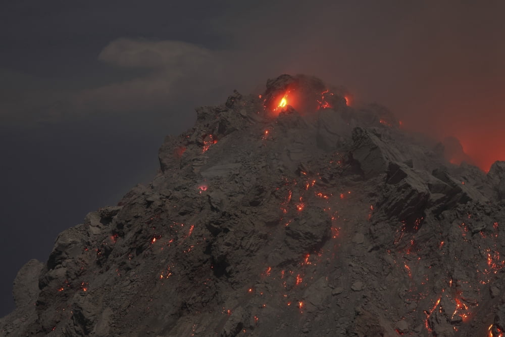 Glowing summit of Rerombola lava dome of Paluweh volcano Canvas Art - Richard RoscoeStocktrek Images (35 x 23)