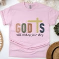 thumbnail image 1 of God’s Still Writing Your Story Christian Cross T-Shirt Unisex, Light Pink, Size S, 1 of 6