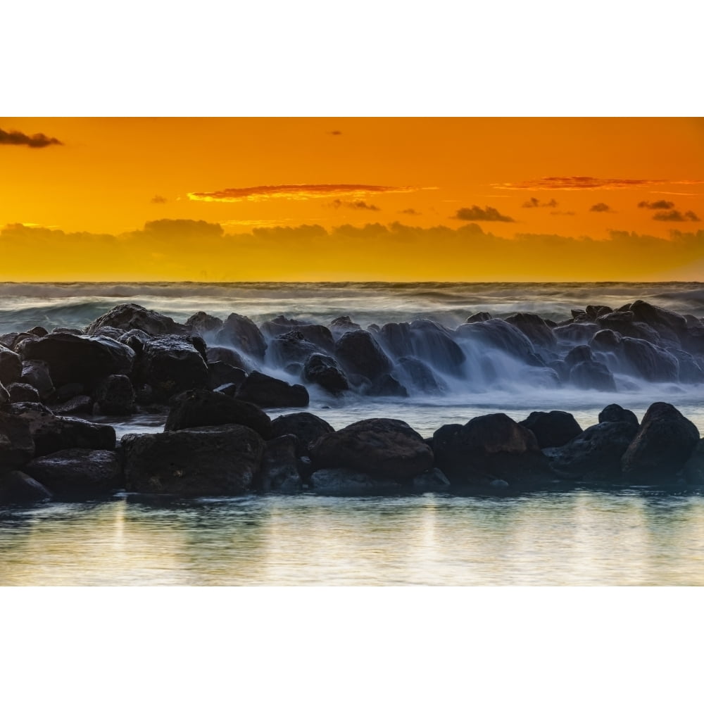 Golden sunrise over Lydgate Park and the ocean from the coast of Kauai ...