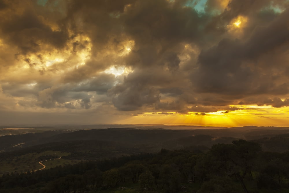 Golden sunset with glowing clouds and silhouetted landscape Israel Canvas Art - Reynold Mainse Design Pics (19 x 12)