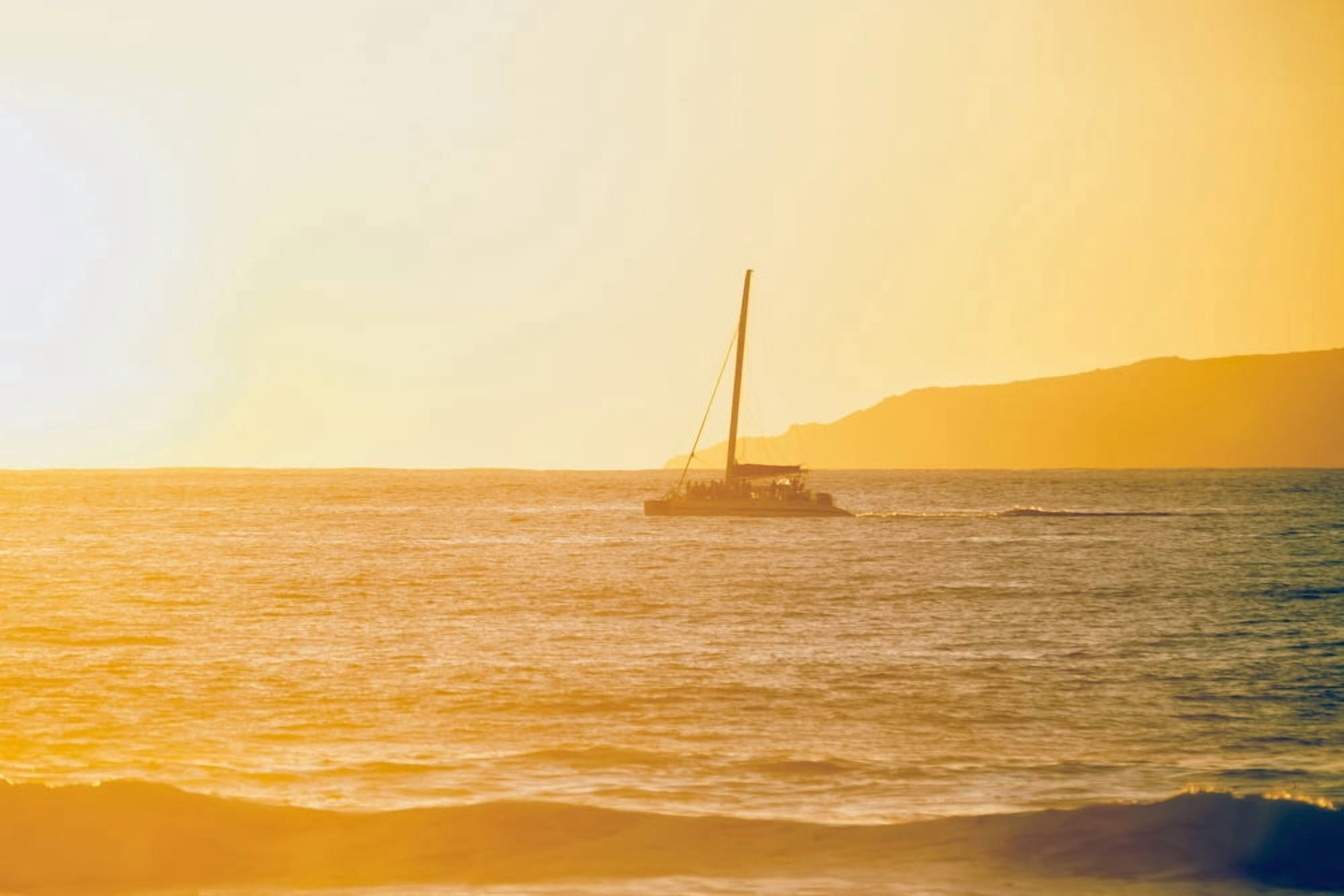 Golden surf visible from Barking Sands Beach with catamaran crossing the channel Kekaha Kauai Hawaii United States of America Canvas Art - Ian Ludwig Design Pics (19 x 12)