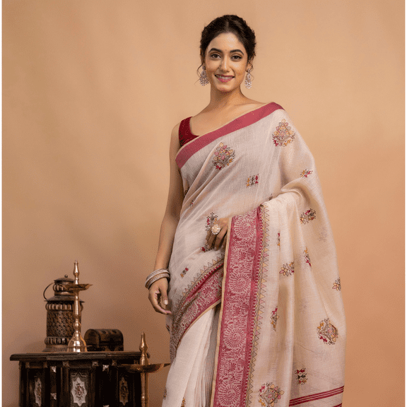 Graceful in Traditional Cream and Red Saree with Intricate Embroidery and Timeless Ethnic Elegance Indoors Setting