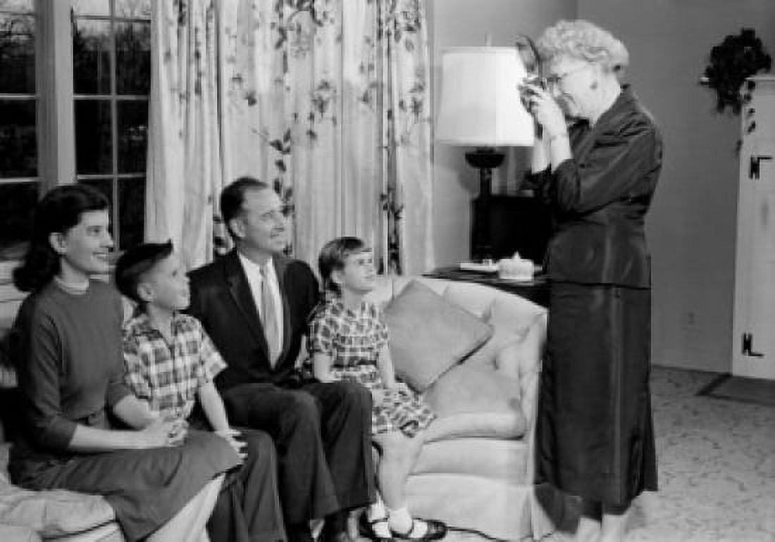 Grandmother taking photo of parents and kids on sofa Canvas Art - (18 x 24)