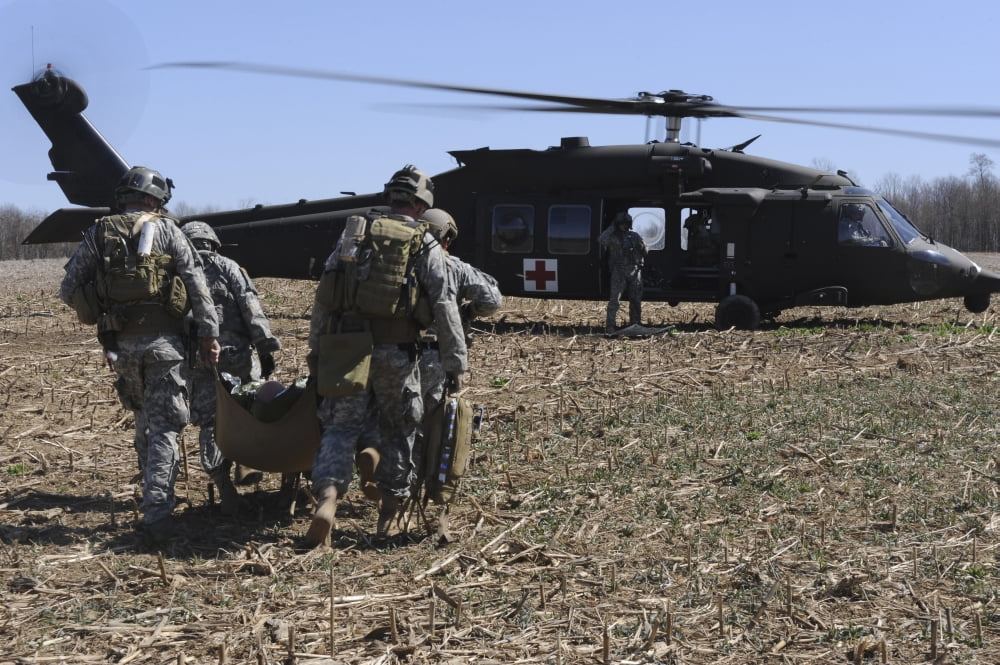 Green Berets move a simulated casualty to a UH-60 helicopter for transport Canvas Art - Stocktrek Images (34 x 23)