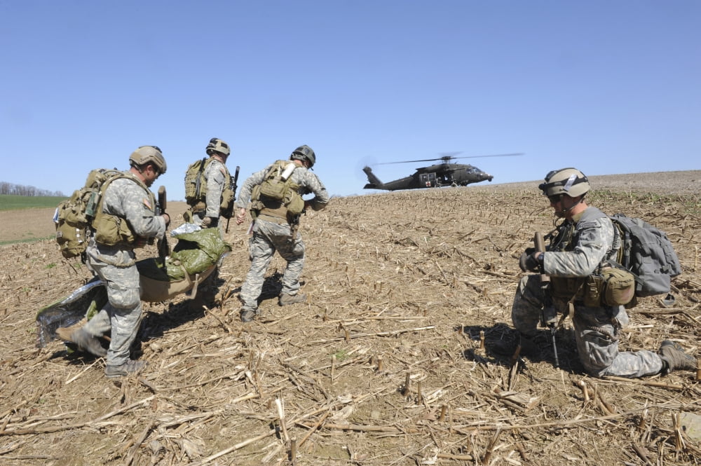 Green Berets move a simulated casualty to a UH-60 helicopter for transport Canvas Art - Stocktrek Images (34 x 23)
