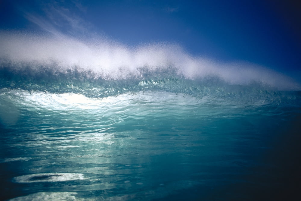 Green Wave With Wind Spray At Tips Backlit With Reflections On Water Blue Sky C1719 Canvas Art - Vince Cavataio Design Pics (19 x 12)
