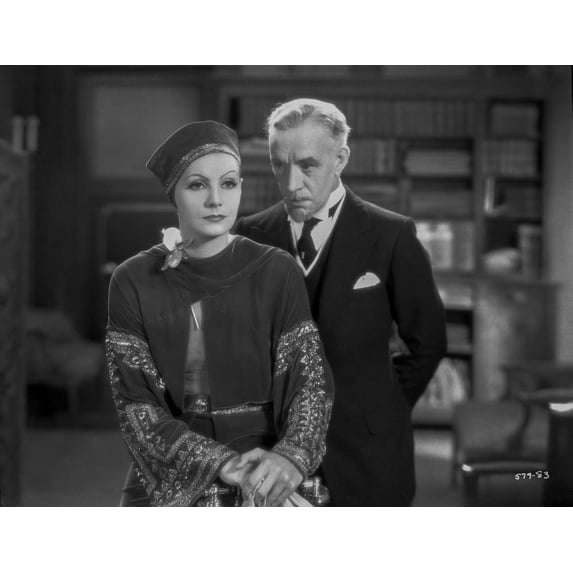Greta Garbo Listening to a Man in Formal Outfit Photo Print (8 x 10)