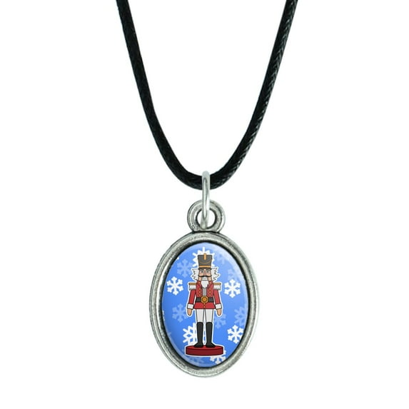 Grinning Nutcracker Soldier with Snowflakes Antiqued Oval Charm Pendant with Black Satin Cord