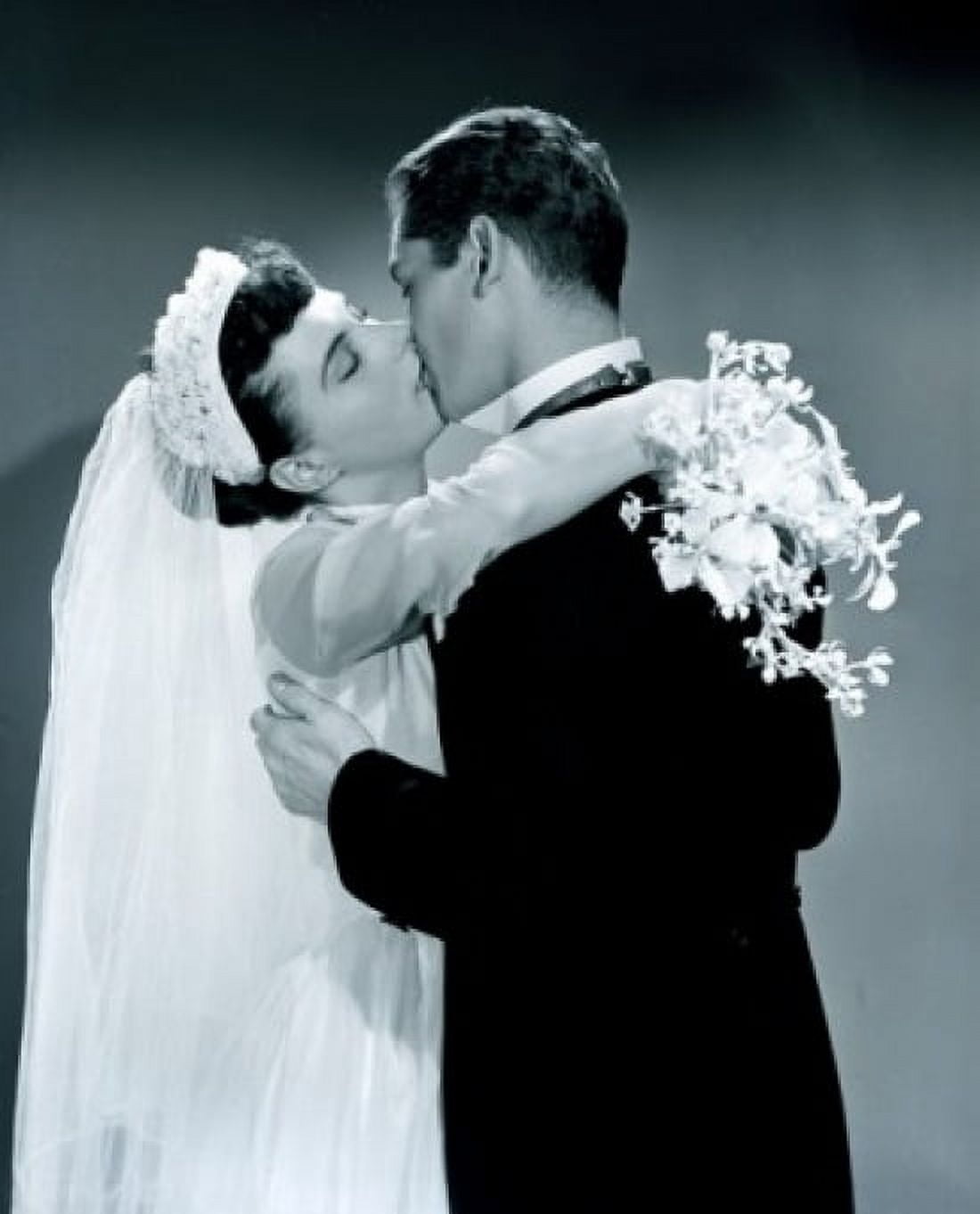 Groom kissing bride holding bouquet Canvas Art - (18 x 24)
