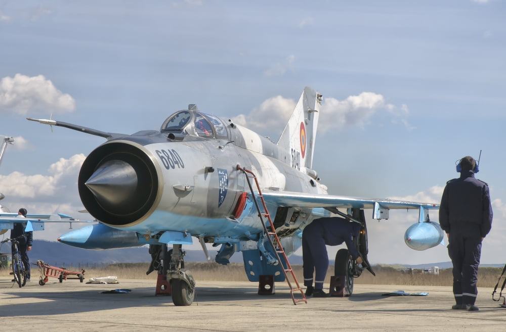 Ground crew conducts maintenance on a Romanian Air Force MiG-21C Canvas Art - Giovanni CollaStocktrek Images (34 x 23)
