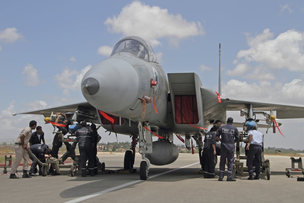 Ground crew equips an F-15C Baz of the Israeli Air Force at Tel Nof Air Base Canvas Art - Ofer ZidonStocktrek Images (35 x 23)