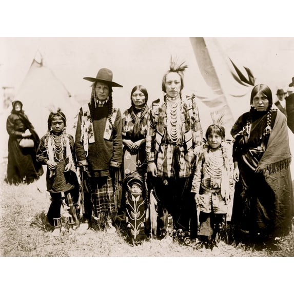 Group of Kootenai Indians, in traditional dress, standing in front of tipi. Poster Print (18 x 24)