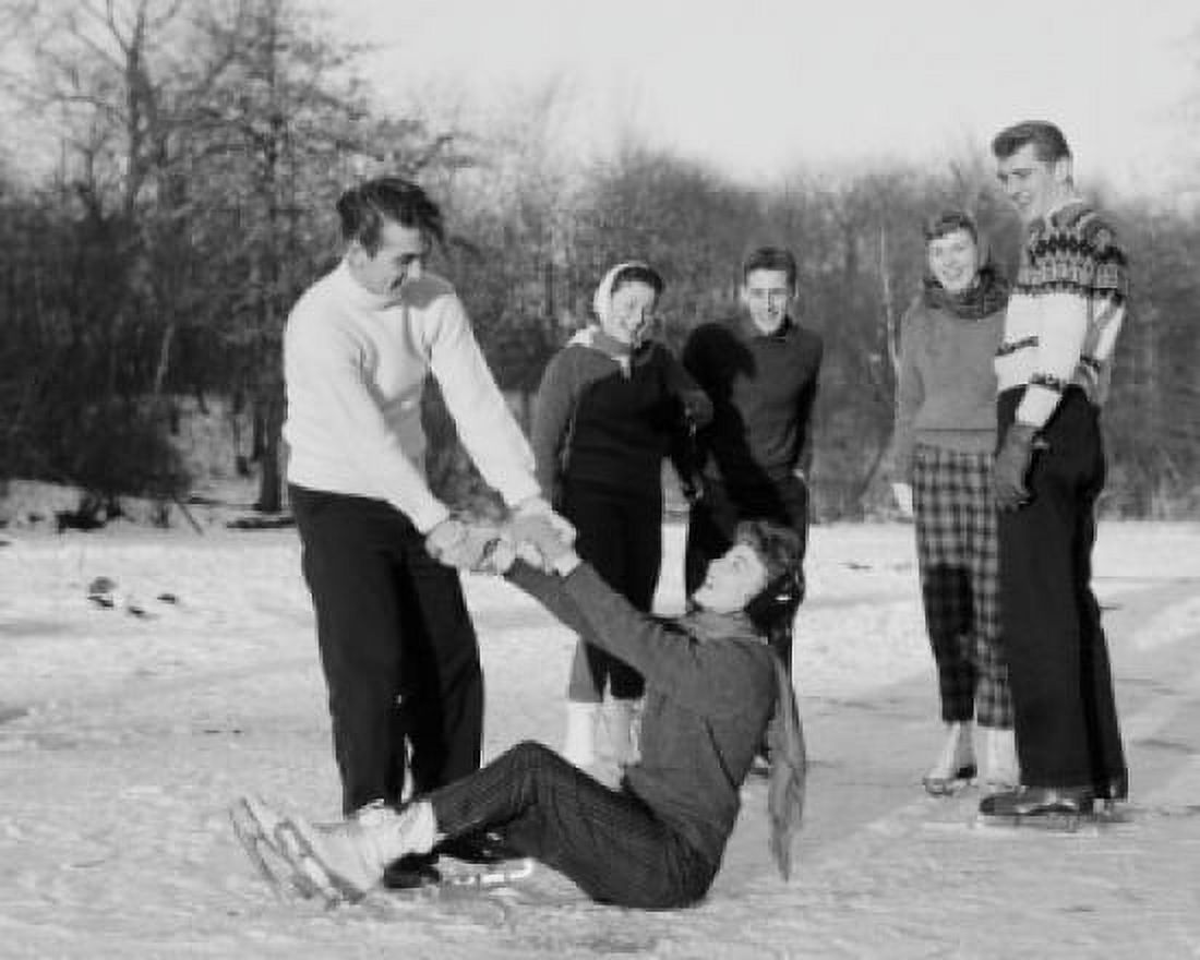 Group of friends on ice rink man helping woman stand up Canvas Art - (24 x 36)