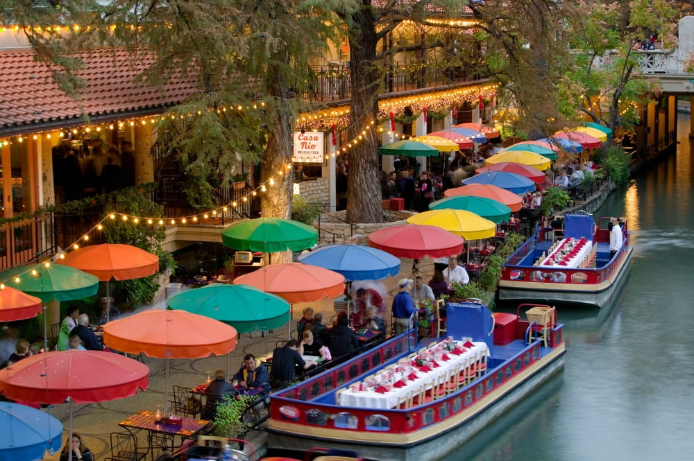 Group of people in a restaurant along a river San Antonio River San Antonio Texas USA Canvas Art - Panoramic Images (36 x 12)
