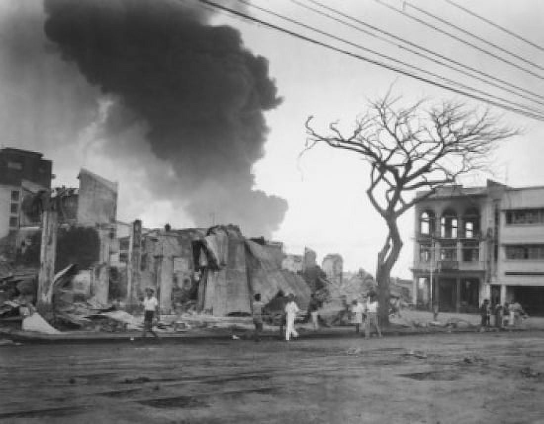 Group of people walking in front of burning buildings Manila Philippines Canvas Art - (18 x 24)