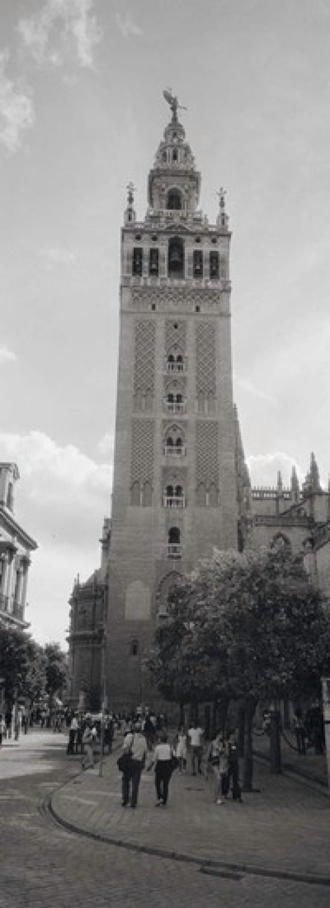 Group of people walking near a church La Giralda Seville Cathedral Seville Seville Province Andalusia Spain Canvas Art - Panoramic Images (18 x 7)