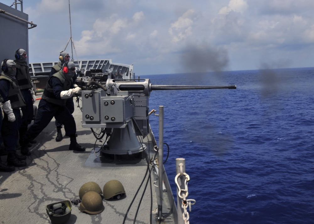 Gunner fires a Mark 38 machine gun aboard USS Frank Cable Canvas Art - Stocktrek Images (34 x 24)