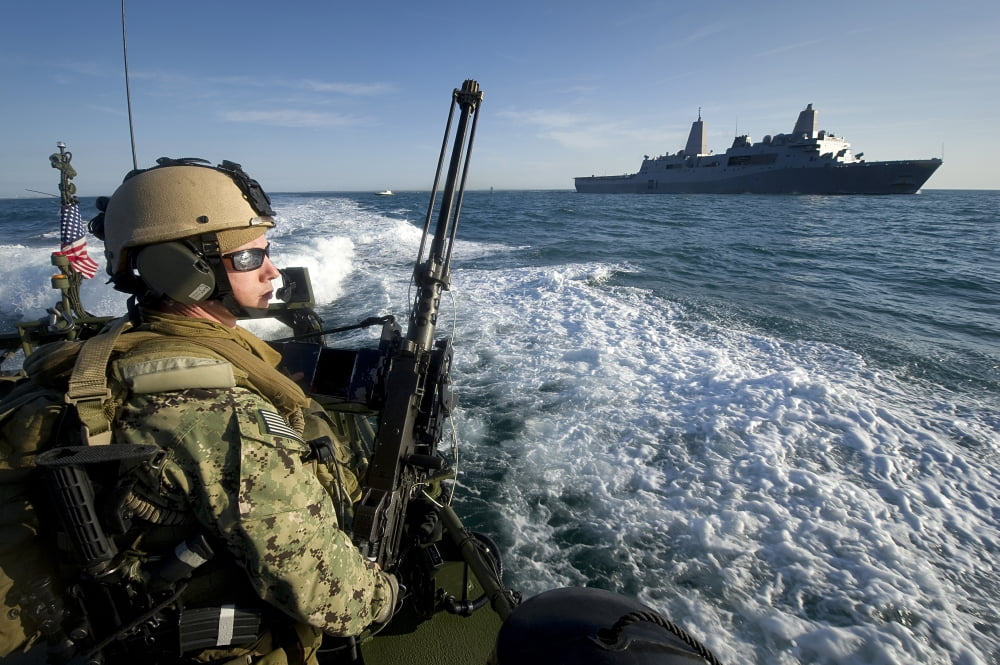 Gunner mans a 50-caliber machine gun on a riverine boat Canvas Art - Stocktrek Images (35 x 23)