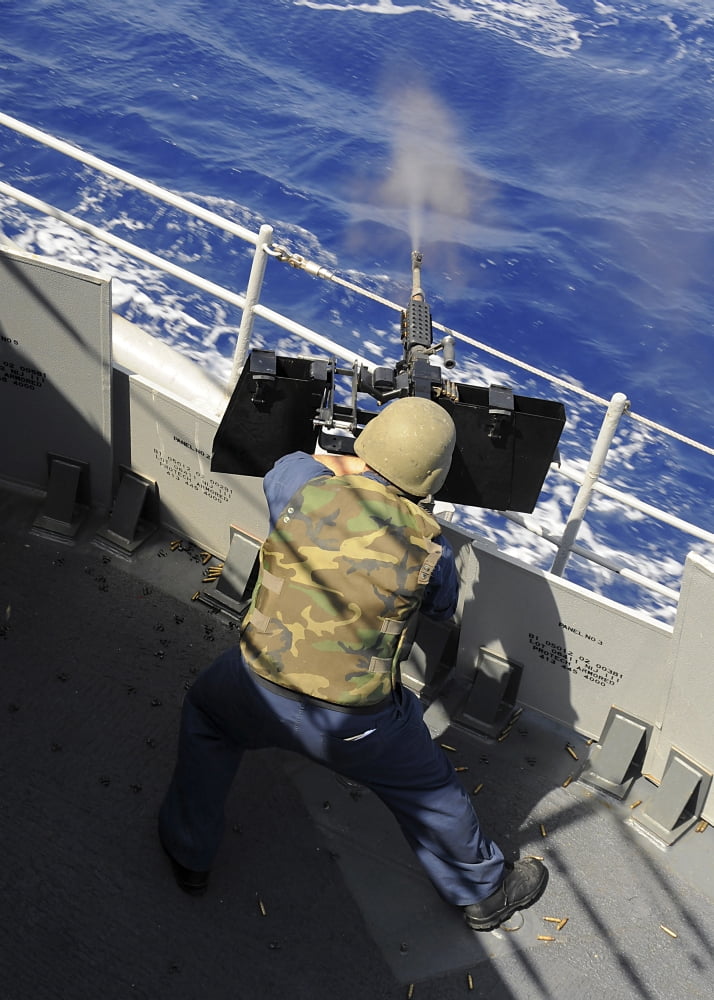 Gunners Mate firing a 50 caliber machine gun aboard the guided-missile cruiser USS Vella Gulf Canvas Art - Stocktrek Images (24 x 34)