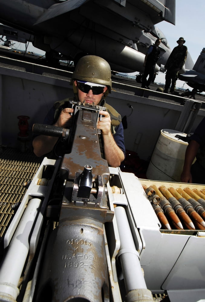 Gunners Mate stands a 50-caliber machine gun force protection watch aboard USS John C Stennis Canvas Art - Stocktrek Images (23 x 34)