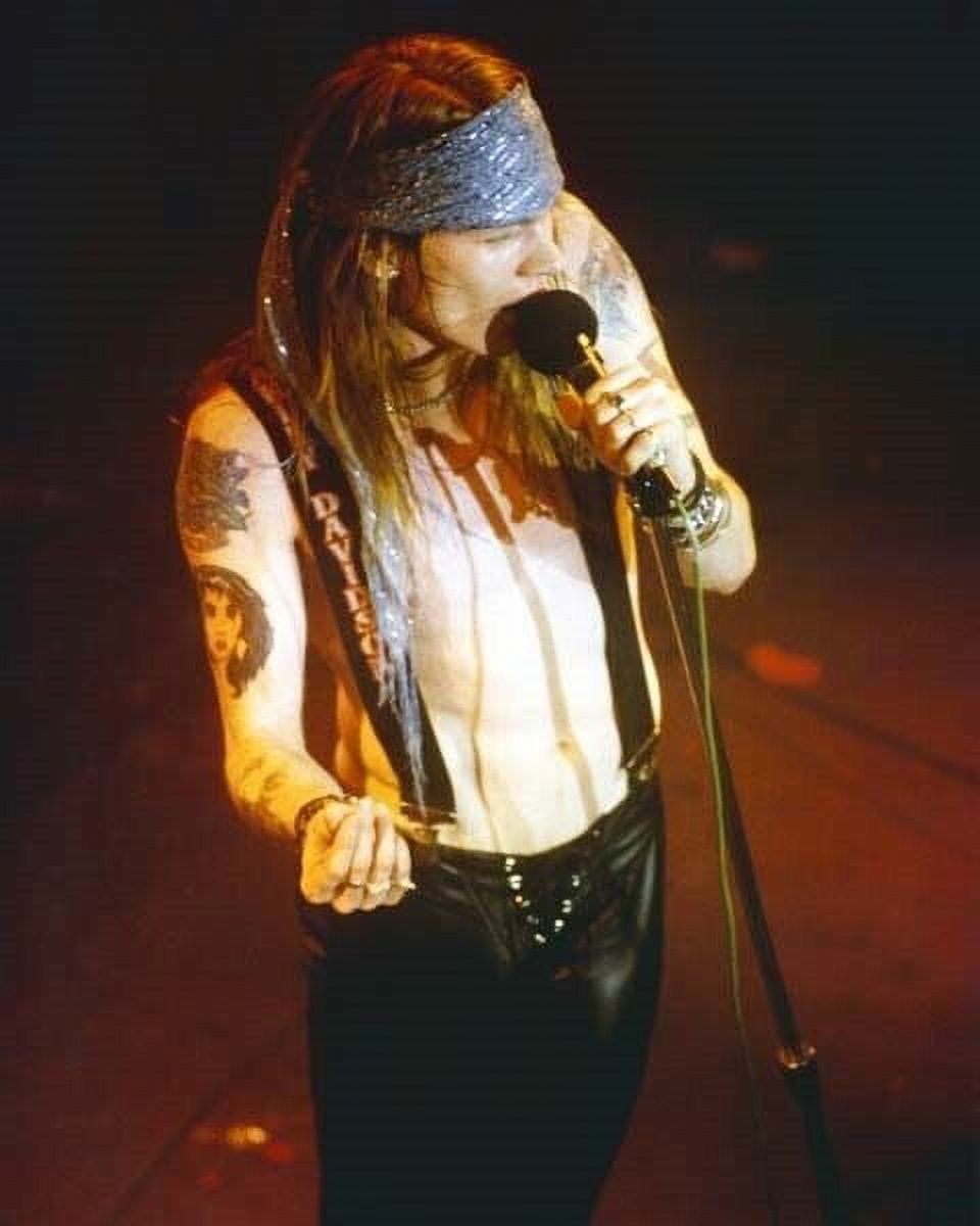 Guns N'Roses front man Axl Rose on stage holding microphone 1980's