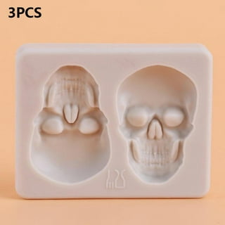 Human skull mold on illuminated studio background - SuperStock