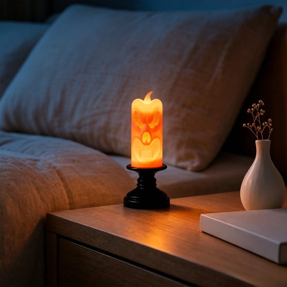 Halloween LED Flameless Candle with Jack-o'-Lantern Face – Flickering Orange Glow on Black Pedestal, Battery-Operated Tabletop Decor for Party & Home Ambiance