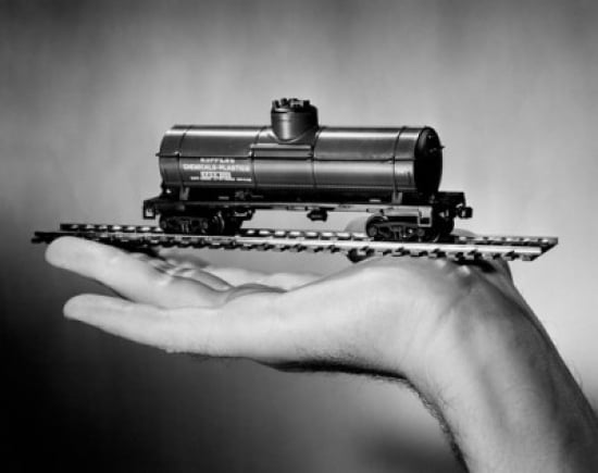Hand holding toy train Canvas Art - (18 x 24)