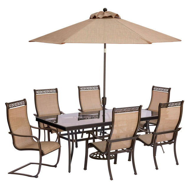 Hanover Outdoor Monaco 7-Piece Sling Dining Set with 42" x 84" Glass-Top Table, 4 Stationary Chairs and 2 C-Spring Chairs plus Umbrella with Stand, Cedar