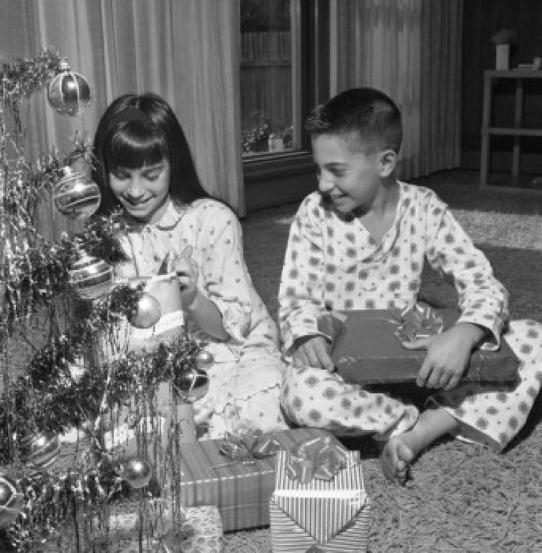 Happy children with Christmas gifts near Christmas tree Canvas Art - (18 x 24)
